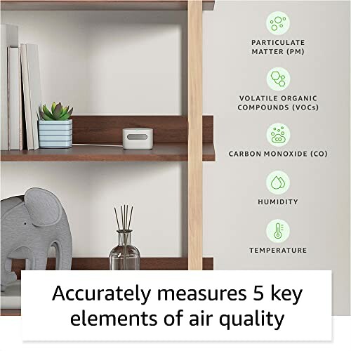 Air quality monitor on a shelf with books and decor.