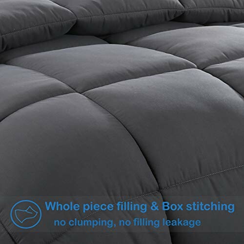 Close-up of a gray quilted comforter with box stitching.