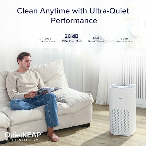 Man sitting on a couch beside a quiet air purifier.