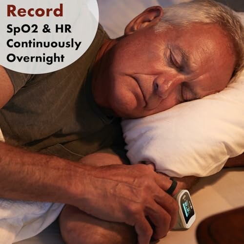 Man sleeping with a SpO2 and heart rate monitor on wrist.
